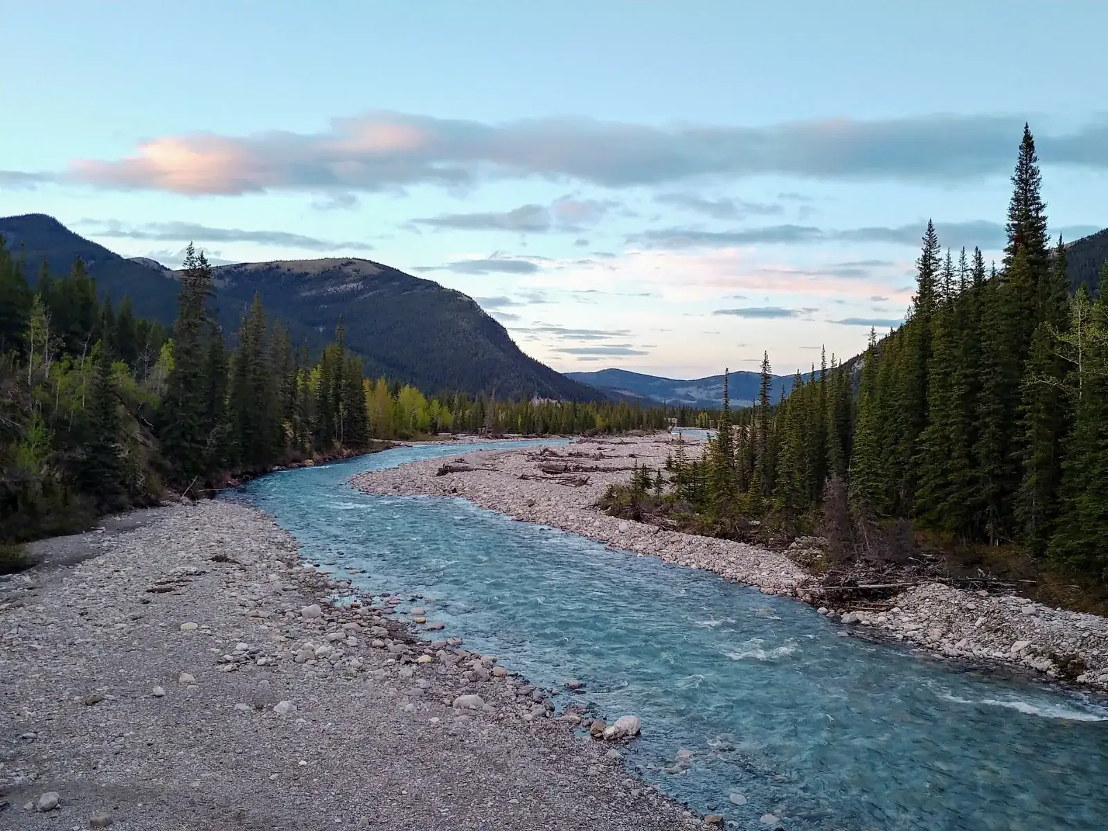 The Little Elbow River in the Bragg Creek area with forested mountains behind