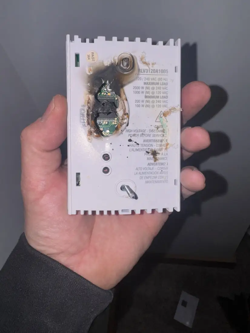 A burnt out electronic wall control removed from a wall