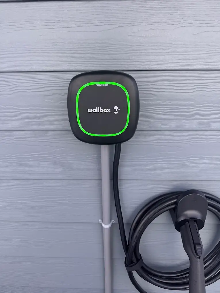 Wallbox EV charger installed on the exterior wall of a home